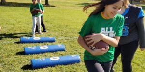 A camper participates in a running back drill during the 2022 Youth Camp.